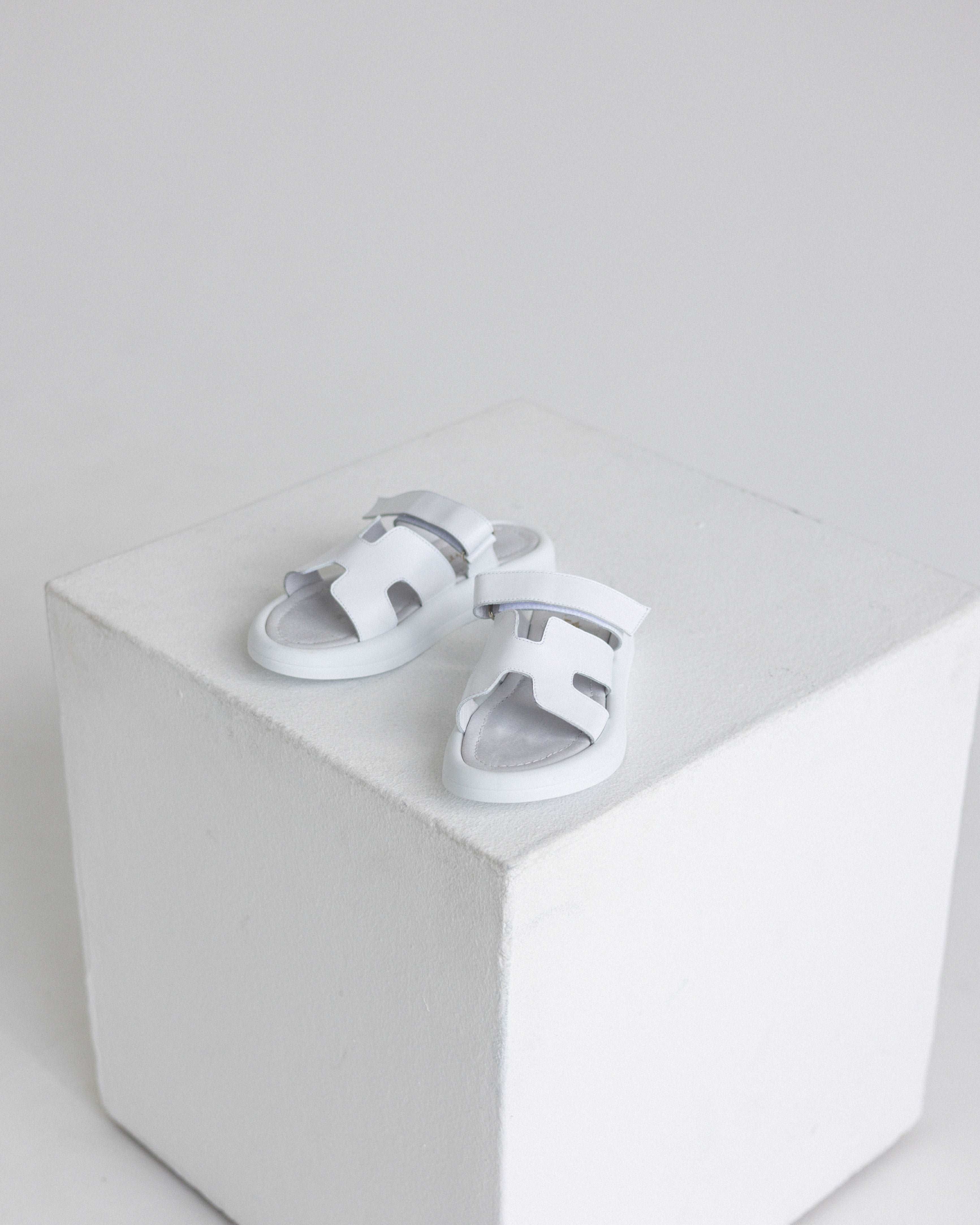 stylish white flip-flops with a fastener