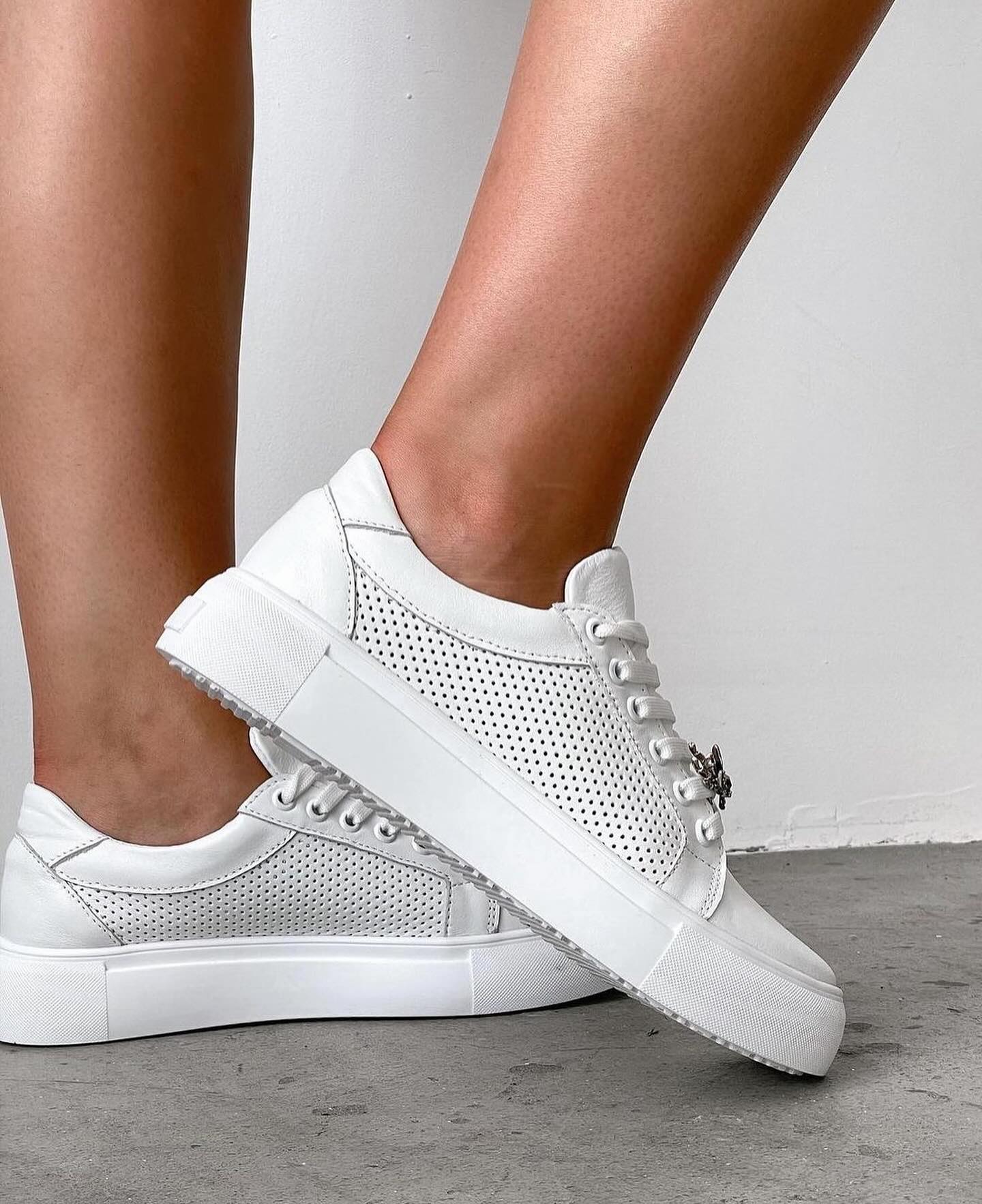 Snow-white sneakers with perforation