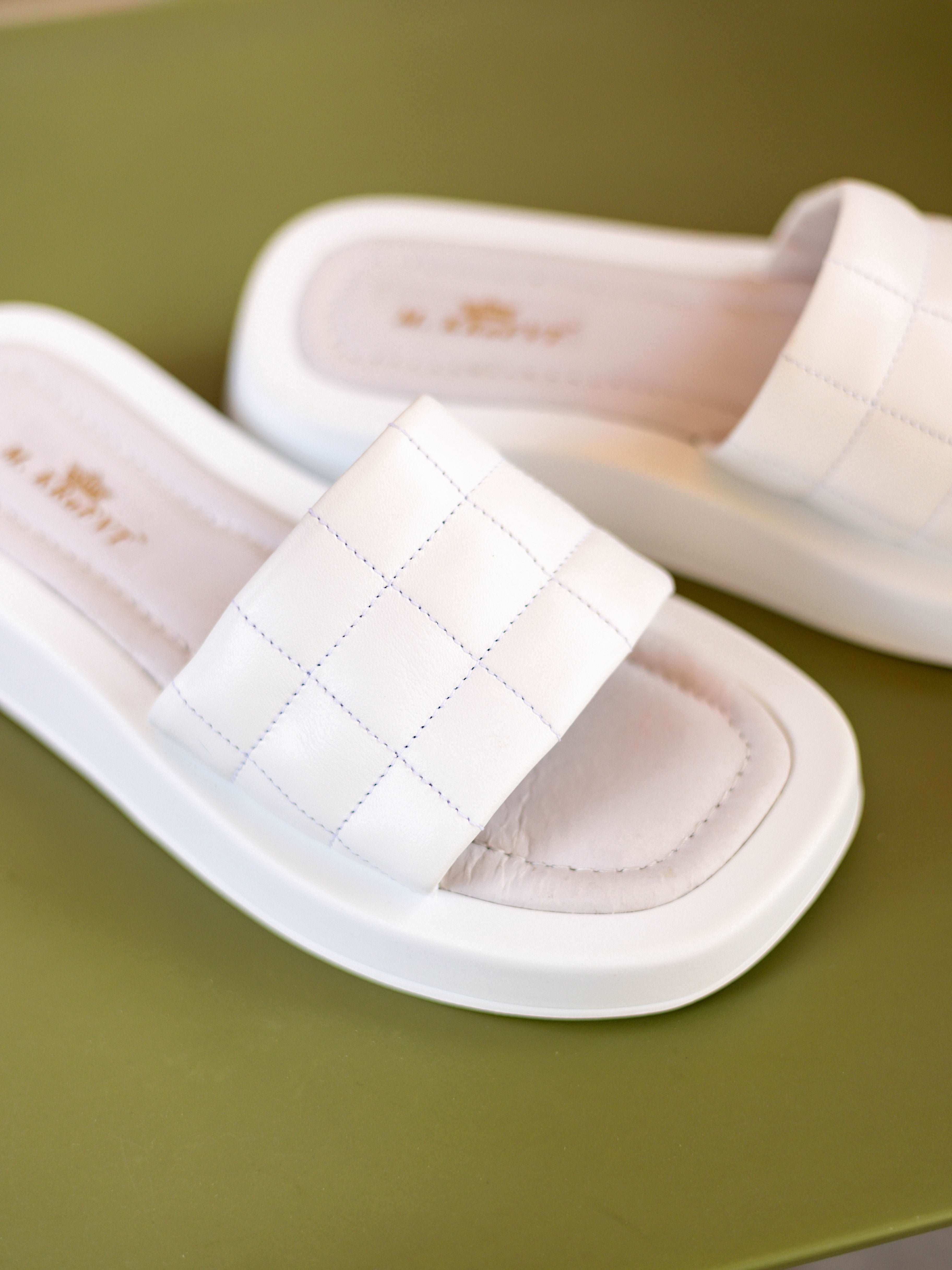 white and delicate flip-flops are perfect for a day out